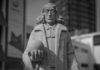 Monochrome stone statue in urban setting
