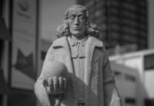 Monochrome stone statue in urban setting