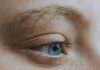 Crop unrecognizable dreamy woman with blue eye