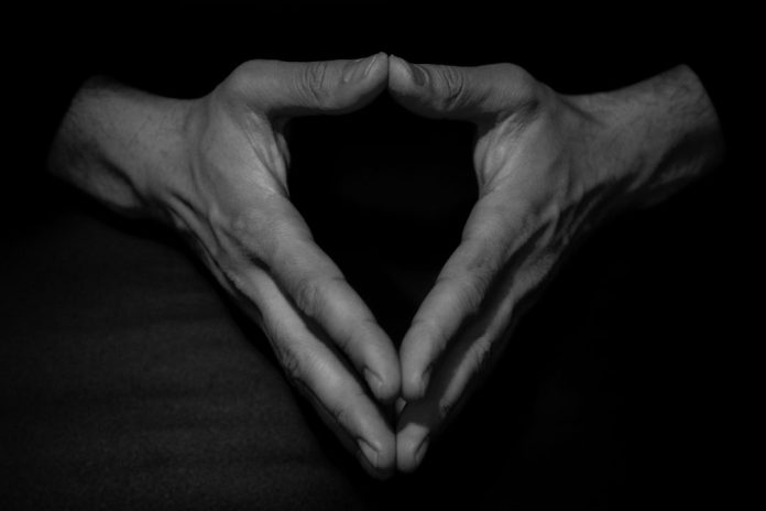 Clasped hands of man